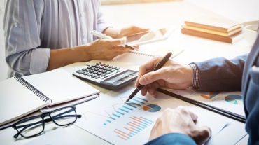 business man financial inspector and secretary making report, calculating or checking balance. Internal Revenue Service inspector checking document. Audit concept