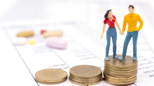 Miniature couple people and stack coins on statement and the drug behind. saving concept.